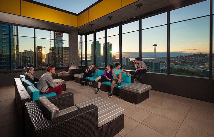 A student lounge on the top has glass walls and is open to the sky.